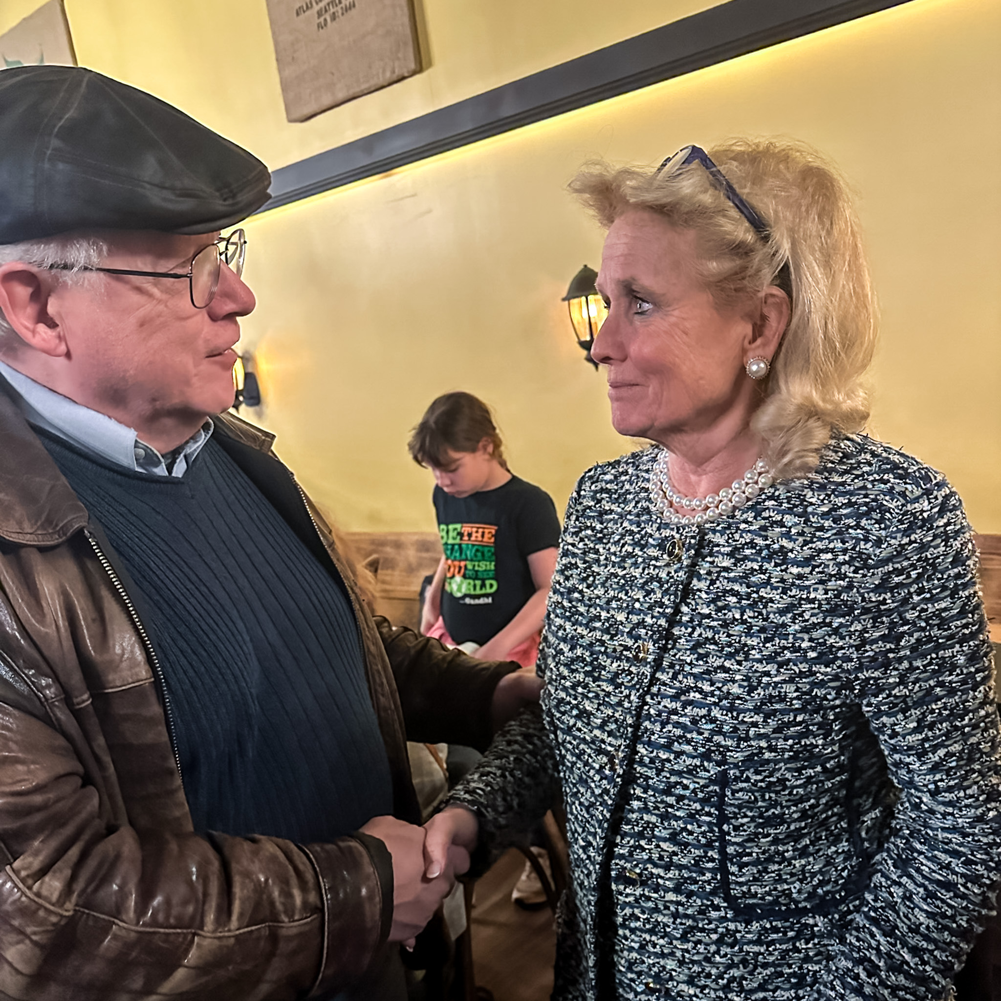 Rep. Dingell shakes hand with resident at town hall