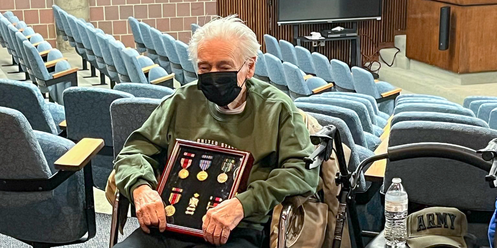 Sgt. William Barksdale poses with services medals at event recognizing his service during WWII